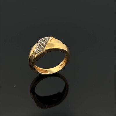 a gold ring with diamonds on a black surface
