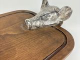 a metal animal head on top of a wooden table