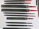 a lot of knives that are lined up on a table