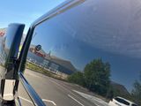 a reflection of a delivery truck on the side of the road