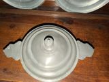 two plates and a bowl sitting on a wooden table