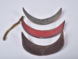 three pieces of metal with red and black paint on them
