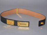 black leather belt with gold metal buckles on a white surface