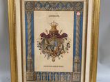 a framed picture of a coat of arms with a gold frame