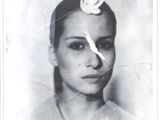 a black and white photo of a woman with a flower in her hair