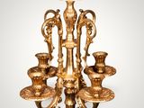 a gold candle holder with five candles on it