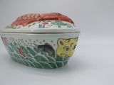 a small bowl with a lid that has a picture of a cat on it
