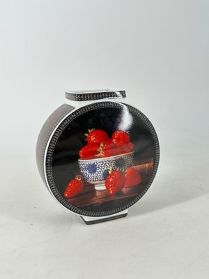 une photo d'un bol de fraises posé sur une table