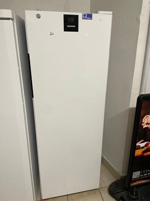 two white refrigerators next to each other in a kitchen