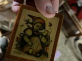 a person holding a small picture of a cat