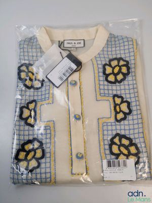 a white shirt with blue and yellow flowers on it