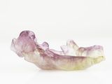 purple and yellow crystal bowl on a white surface