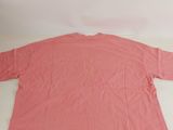 a pink shirt laying on top of a white table