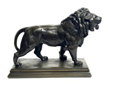 bronze statue of a lion on a marble base on a white background