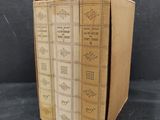 three books are stacked on top of each other on a table