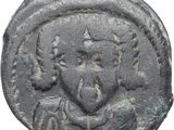 une pièce de monnaie ancienne sur laquelle figure la tête d'un homme