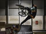 a man doing a trick on a bike on a ramp