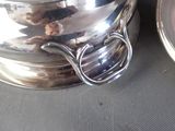 a silver plate with a spoon and a bowl on it