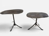 une paire de tables d'appoint avec des pieds en métal et un plateau sur fond blanc