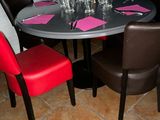 a table with four chairs and a table with place settings on it