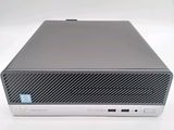 the hp desktop computer is sitting on a white surface