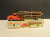 a toy truck with a load of logs on top of it