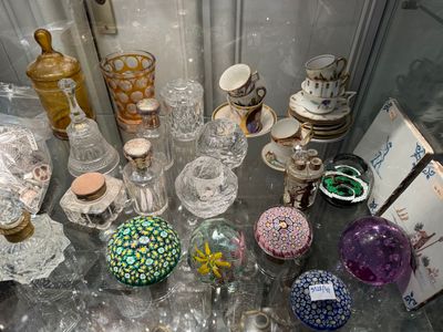 many different glass vases on display on a glass table