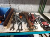 many wrenches and other tools sitting on a table