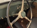 a steering wheel and dashboard of a car in a garage