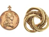 two gold rings and a penny on a white background