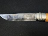 a knife that is sitting on a black surface
