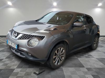 a picture of a grey nissan juke suv parked in a showroom