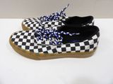 pair of black and white checkered shoes with blue and white laces