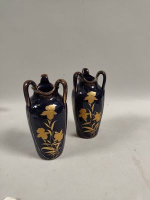 two vases that are sitting on a table