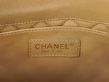 a close up of a chanel bag with a tag on it