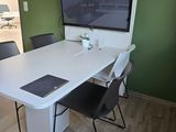 a white table with a laptop on it in a room