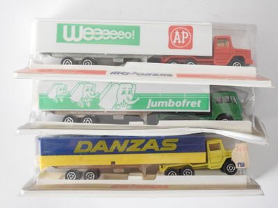 three toy trucks that are stacked on top of each other