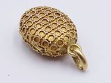 an image of a gold plated pendant on a white surface