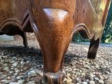 a close up view of a wooden bench on the ground