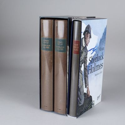 three books are stacked on top of each other on a table