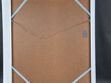 a close up of a picture frame with a cork board attached to it