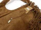 the brown sued bag has fringes on it and a tag on it