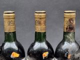 three bottles of wine sitting on top of a table next to each other