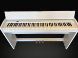 an image of a white piano with black and white keys on a black background