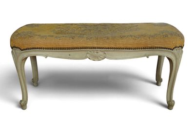 an old bench with a yellow upholstered seat on it
