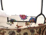 an image of a white purse with a floral design on it