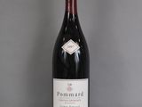 a bottle of wine that is sitting on a glass table