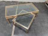 two tables with glass tops sitting on the floor