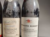 three bottles of wine are lined up on a table