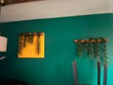a room with a chair and a painting on the wall
